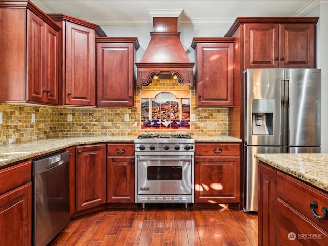 kitchen featuring reddish brown cabinets, stainless steel appliances, dark wood-type flooring, and crown molding