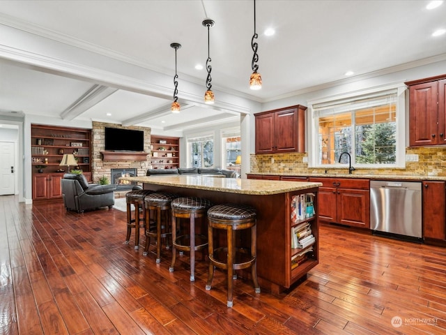 kitchen with a breakfast bar area, dark wood-type flooring, dishwasher, and a center island