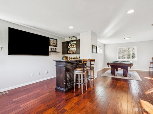 bar featuring recessed lighting, visible vents, baseboards, a bar, and dark wood finished floors