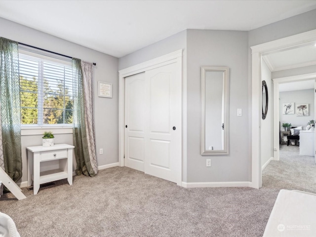 bedroom with a closet, carpet, and baseboards