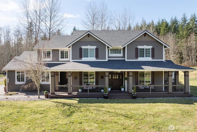 view of front of house featuring a shingled roof, a porch, and a front yard