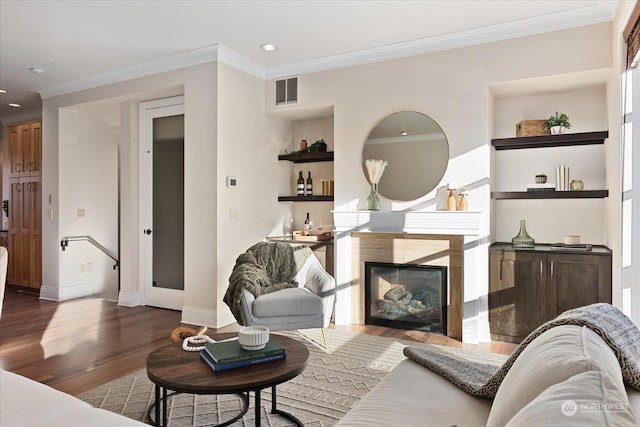 living room with crown molding and hardwood / wood-style floors