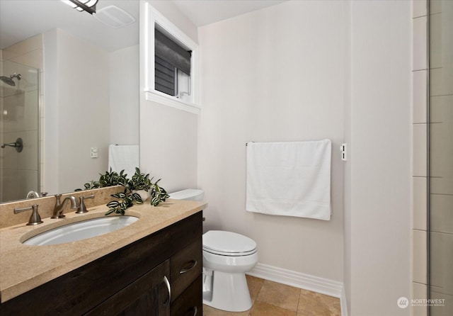 bathroom featuring vanity, a shower with door, tile patterned floors, and toilet