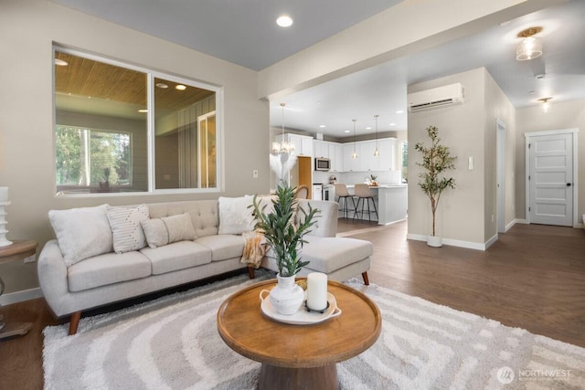 living area with recessed lighting, baseboards, a wall unit AC, and dark wood-style floors