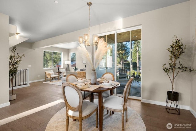 dining room with baseboards, wood finished floors, and a chandelier