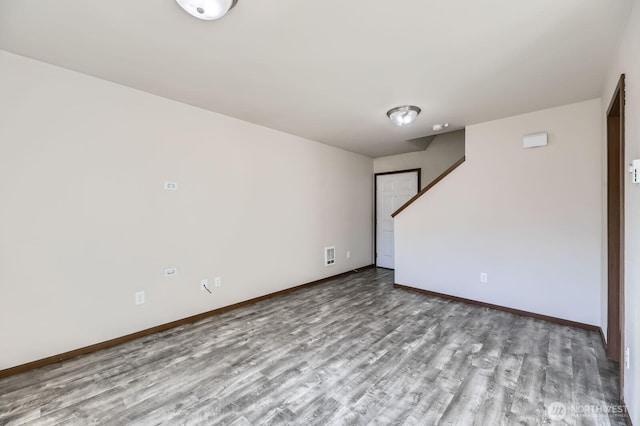 interior space featuring wood finished floors and baseboards