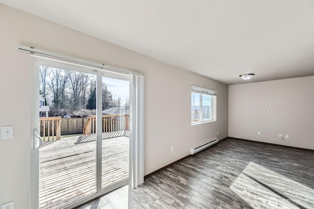 spare room with a baseboard radiator, baseboards, and wood finished floors