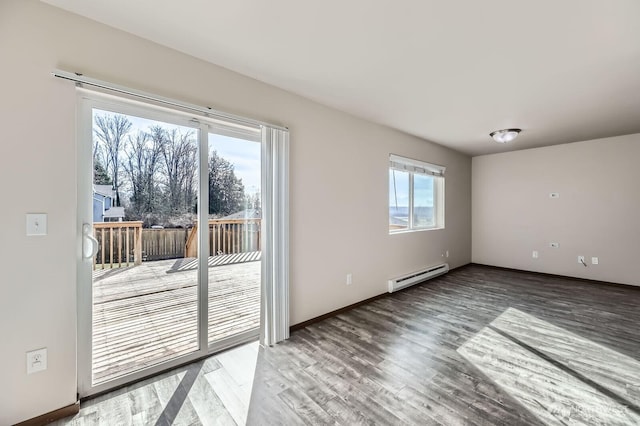 unfurnished room with a baseboard radiator, baseboards, and wood finished floors