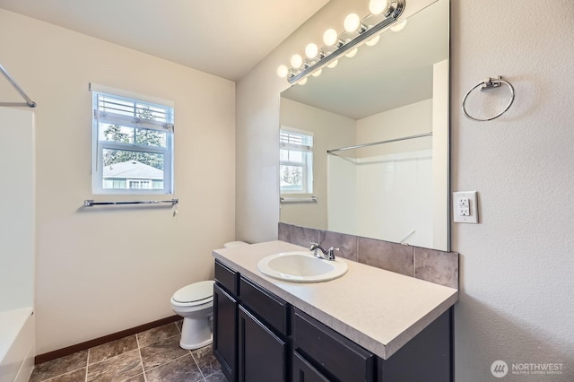 full bath with toilet, baseboards, and vanity