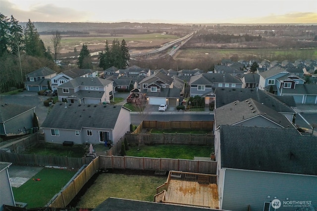 aerial view at dusk featuring a residential view