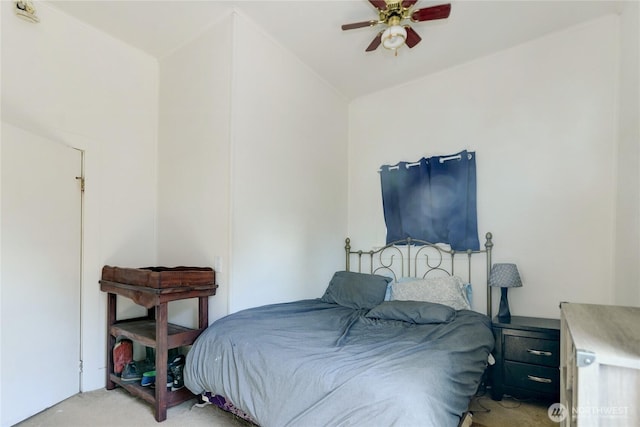 bedroom featuring lofted ceiling, ceiling fan, and light colored carpet