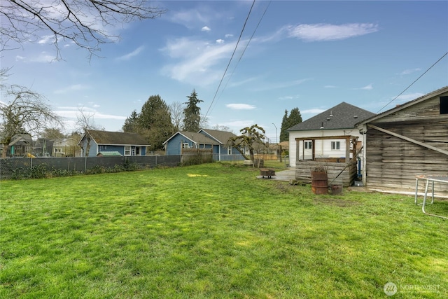 view of yard featuring a residential view and fence