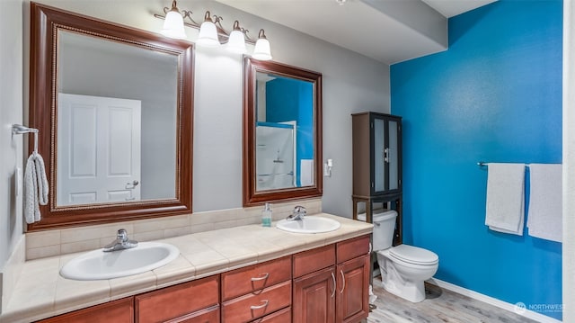 bathroom with vanity, hardwood / wood-style flooring, and toilet