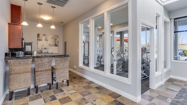 kitchen with a kitchen bar and hanging light fixtures