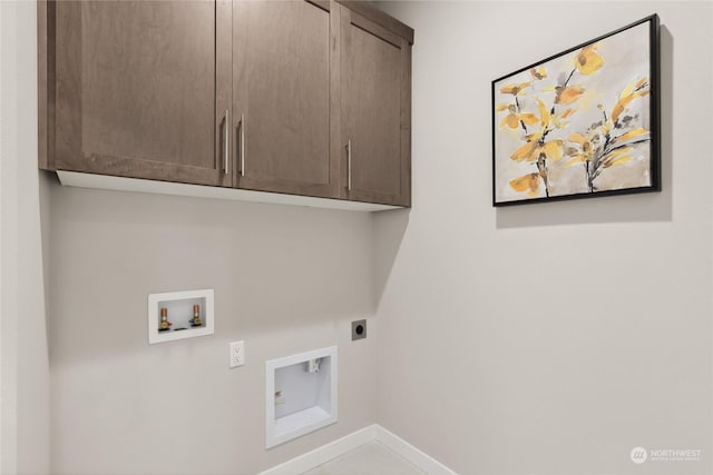 laundry room featuring electric dryer hookup, hookup for a washing machine, and cabinets