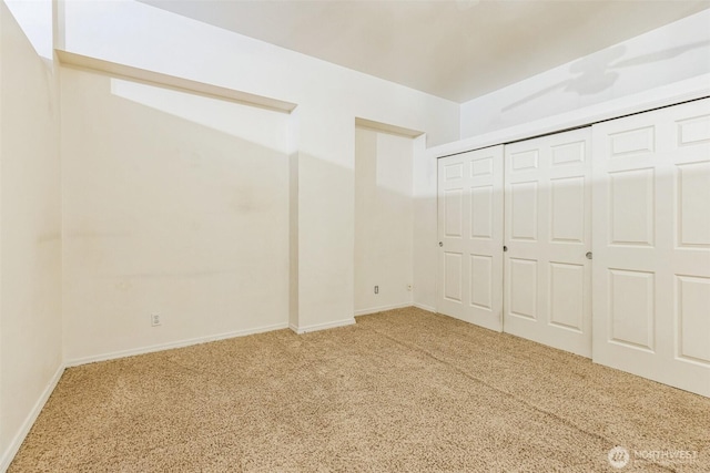 unfurnished bedroom featuring carpet floors and a closet