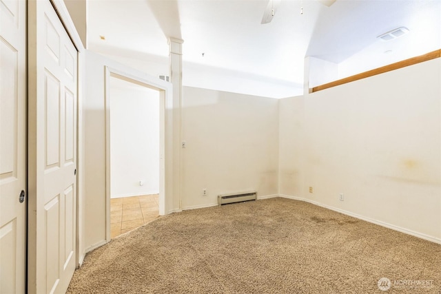 spare room featuring carpet floors, a baseboard heating unit, and ceiling fan