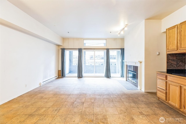 unfurnished living room with a baseboard radiator and a fireplace