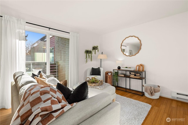 living room featuring wood-type flooring and baseboard heating