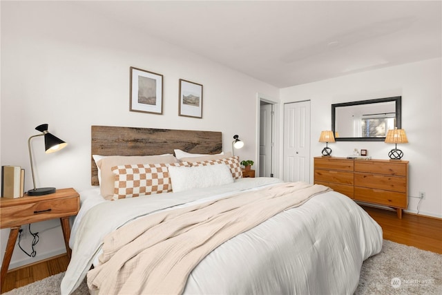 bedroom featuring hardwood / wood-style flooring and a closet