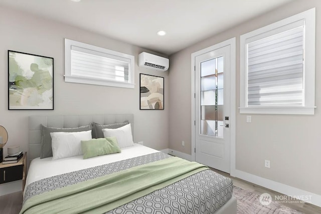 bedroom with hardwood / wood-style flooring and a wall unit AC