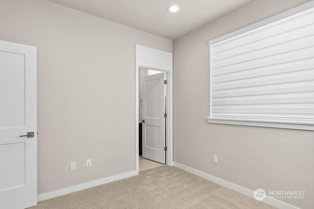 unfurnished bedroom with light colored carpet