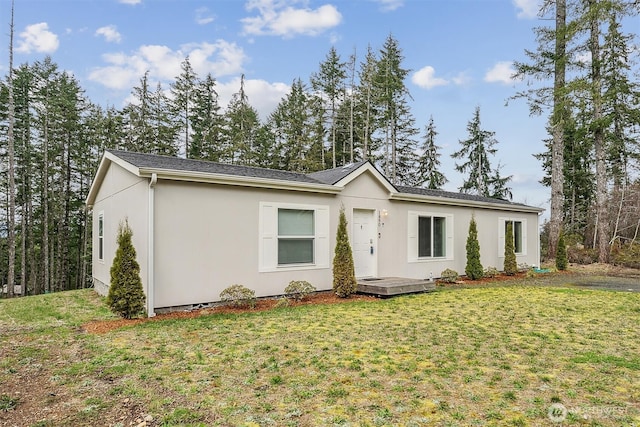 single story home with stucco siding and a front yard