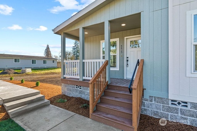 view of exterior entry with a porch