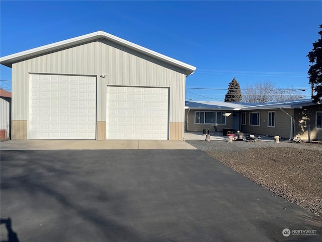 view of front of house with a garage and an outdoor structure