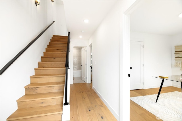 stairs featuring hardwood / wood-style floors, recessed lighting, and baseboards