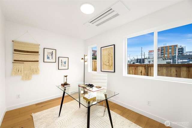 office with baseboards and wood finished floors
