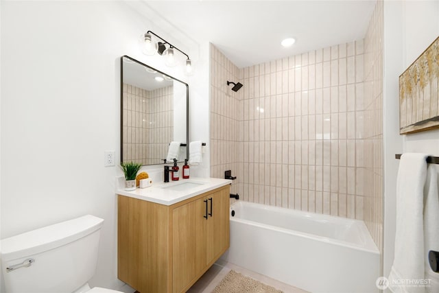 full bathroom featuring tub / shower combination, toilet, vanity, and tile patterned flooring