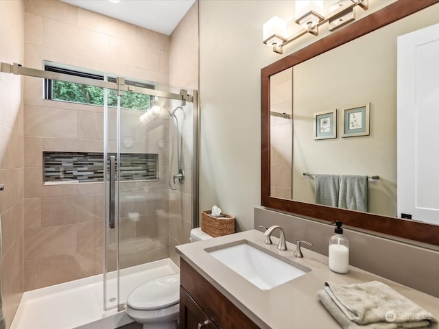 full bathroom with a stall shower, toilet, and vanity