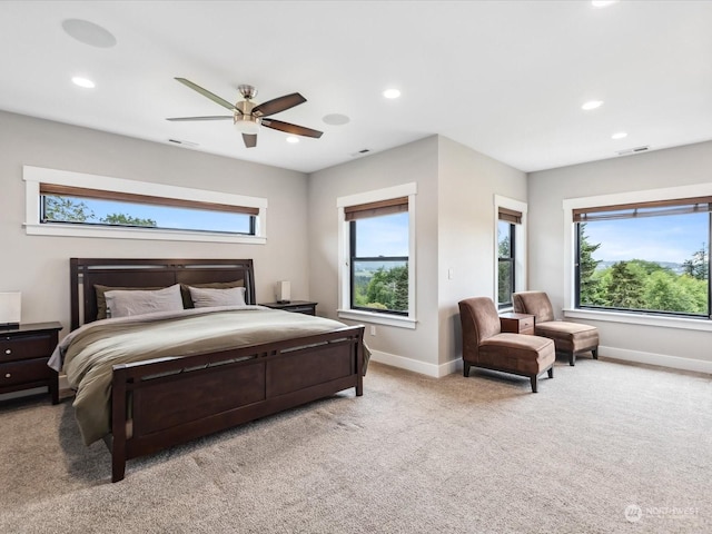 bedroom with visible vents, baseboards, and multiple windows
