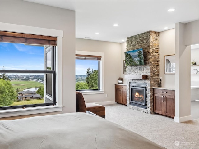 bedroom with visible vents, light carpet, recessed lighting, a fireplace, and baseboards