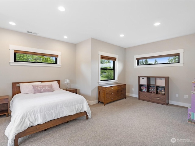 bedroom featuring visible vents, recessed lighting, light colored carpet, and baseboards
