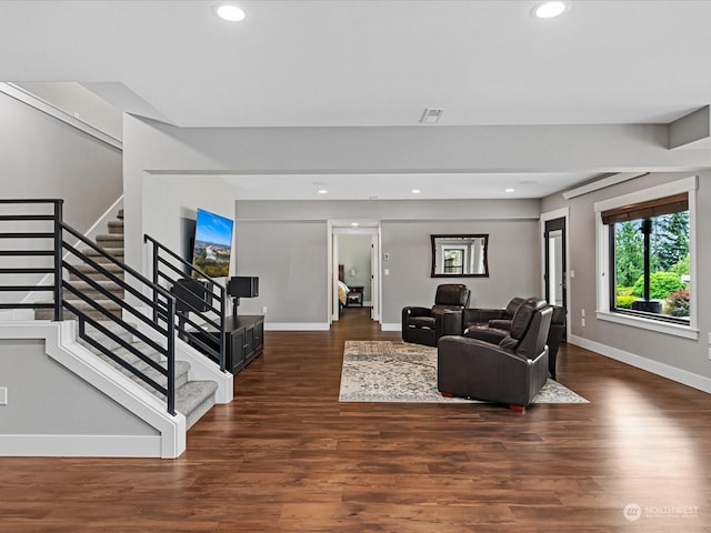 living area with recessed lighting, stairway, baseboards, and wood finished floors