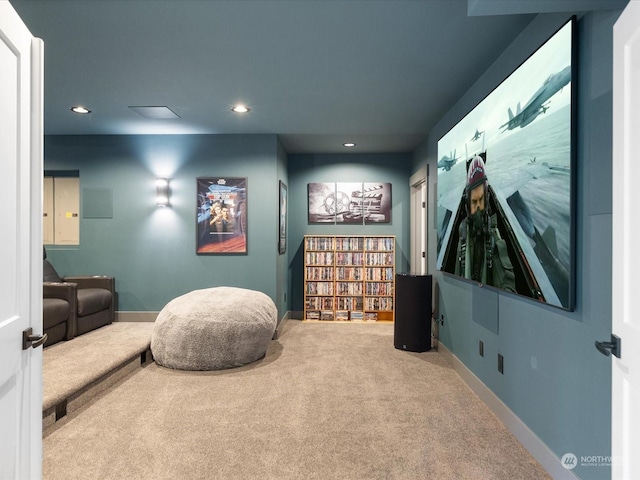 carpeted home theater room with recessed lighting and baseboards