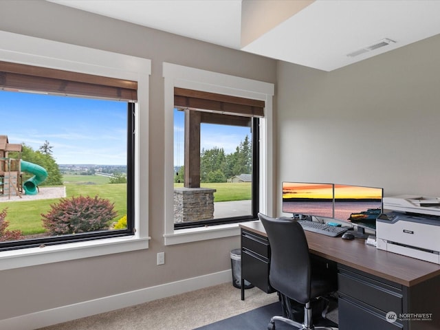 carpeted home office featuring visible vents and baseboards