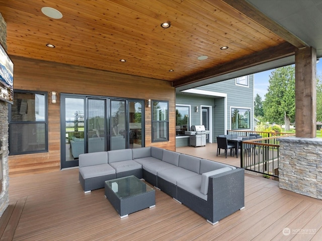 wooden terrace with outdoor dining area, grilling area, and outdoor lounge area