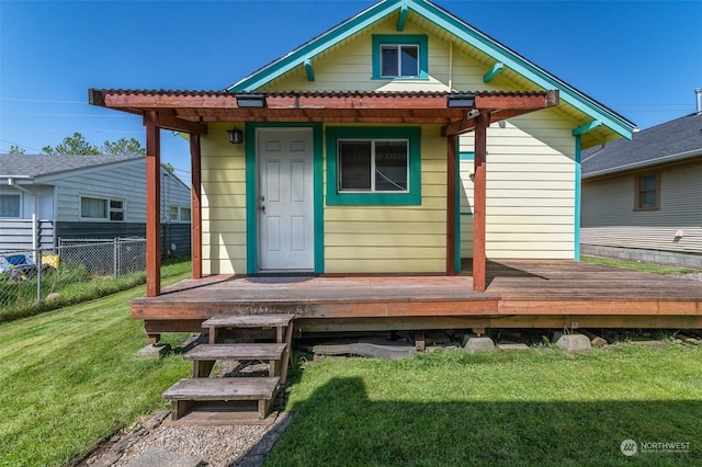 back of property featuring a yard and a deck