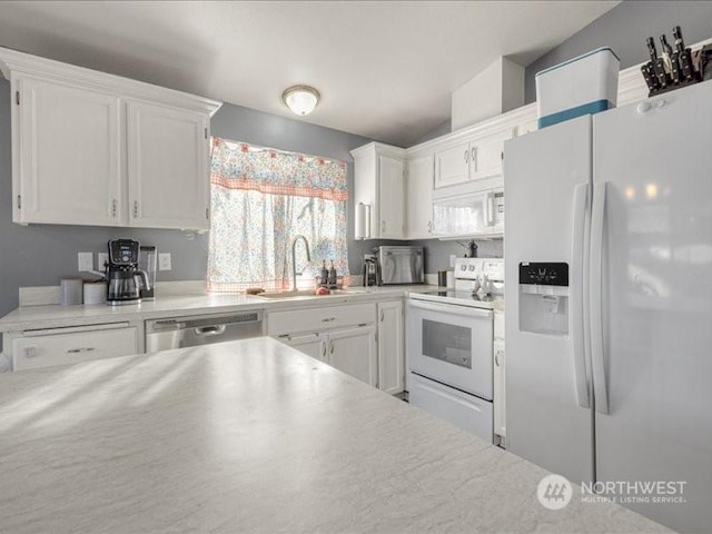 kitchen featuring white cabinetry, white appliances, vaulted ceiling, and sink