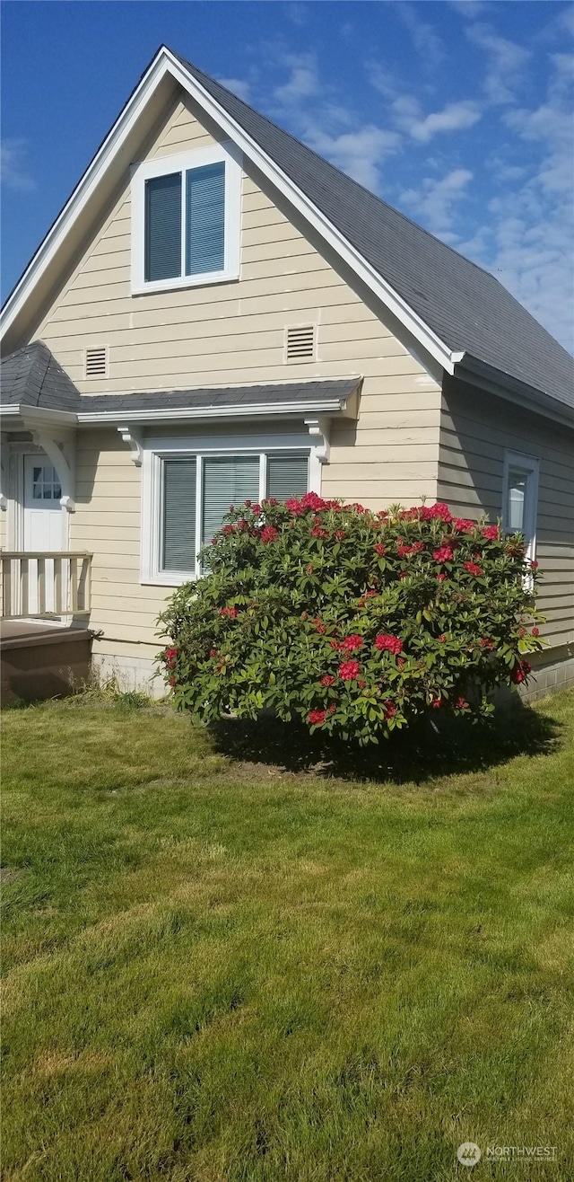 view of home's exterior with a yard