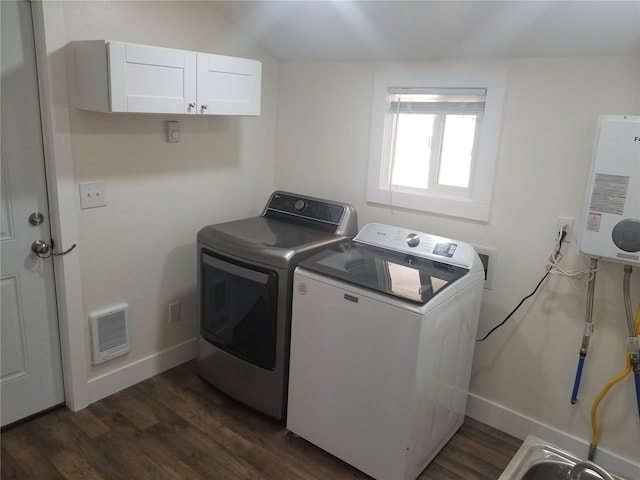 4535 S M St, Tacoma, WA 98418 - clothes washing area with washing machine and dryer, water heater, baseboards, visible vents, and dark wood-style floors