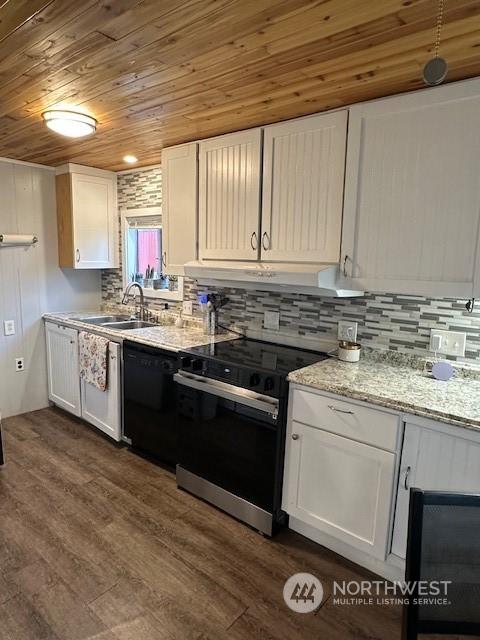 kitchen featuring white cabinetry, sink, and electric range