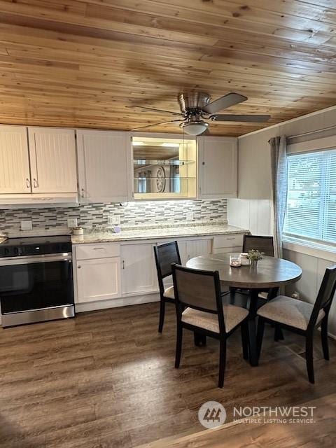 dining room with dark hardwood / wood-style flooring, wooden ceiling, and ceiling fan