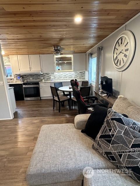 living room featuring wood ceiling, ceiling fan, and dark hardwood / wood-style floors