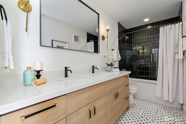 full bathroom featuring vanity, shower / bath combination with curtain, tile patterned floors, and toilet