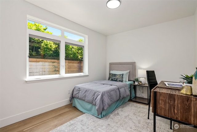 bedroom with wood-type flooring