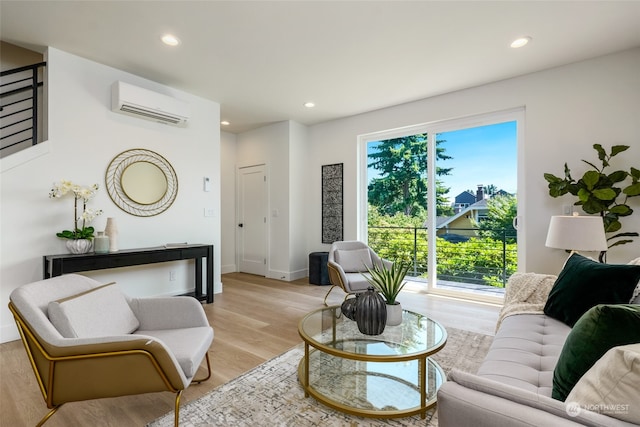 living room with a wall mounted air conditioner and light wood-type flooring